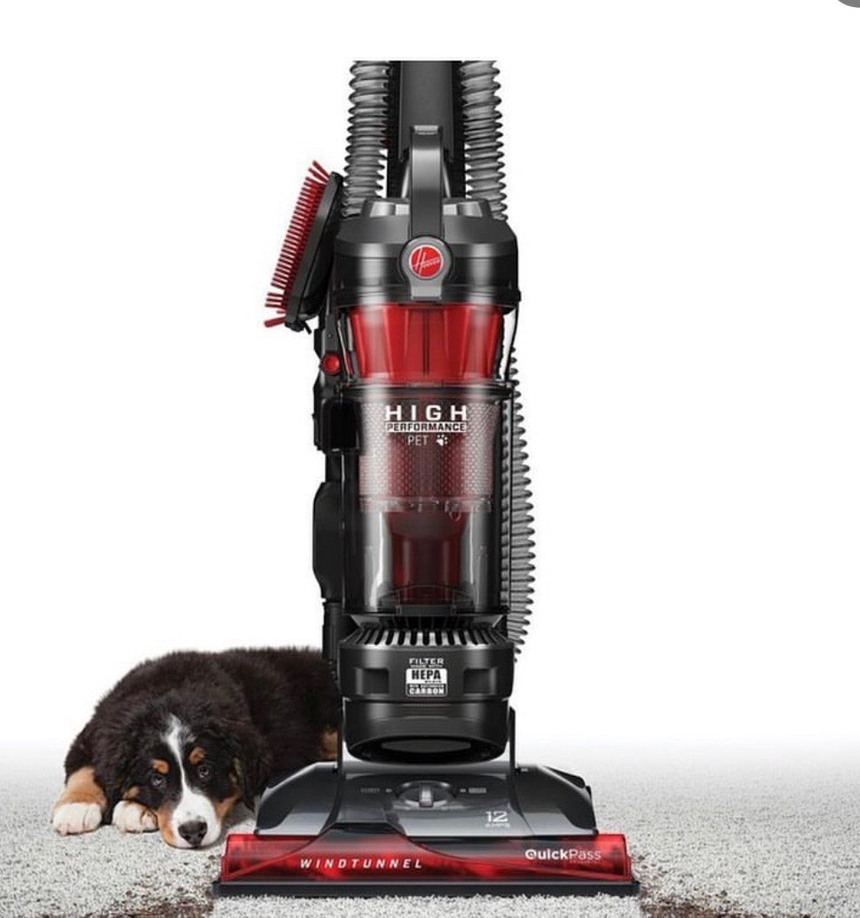 Hoover WindTunnel pet vacuum on carpet beside a dog